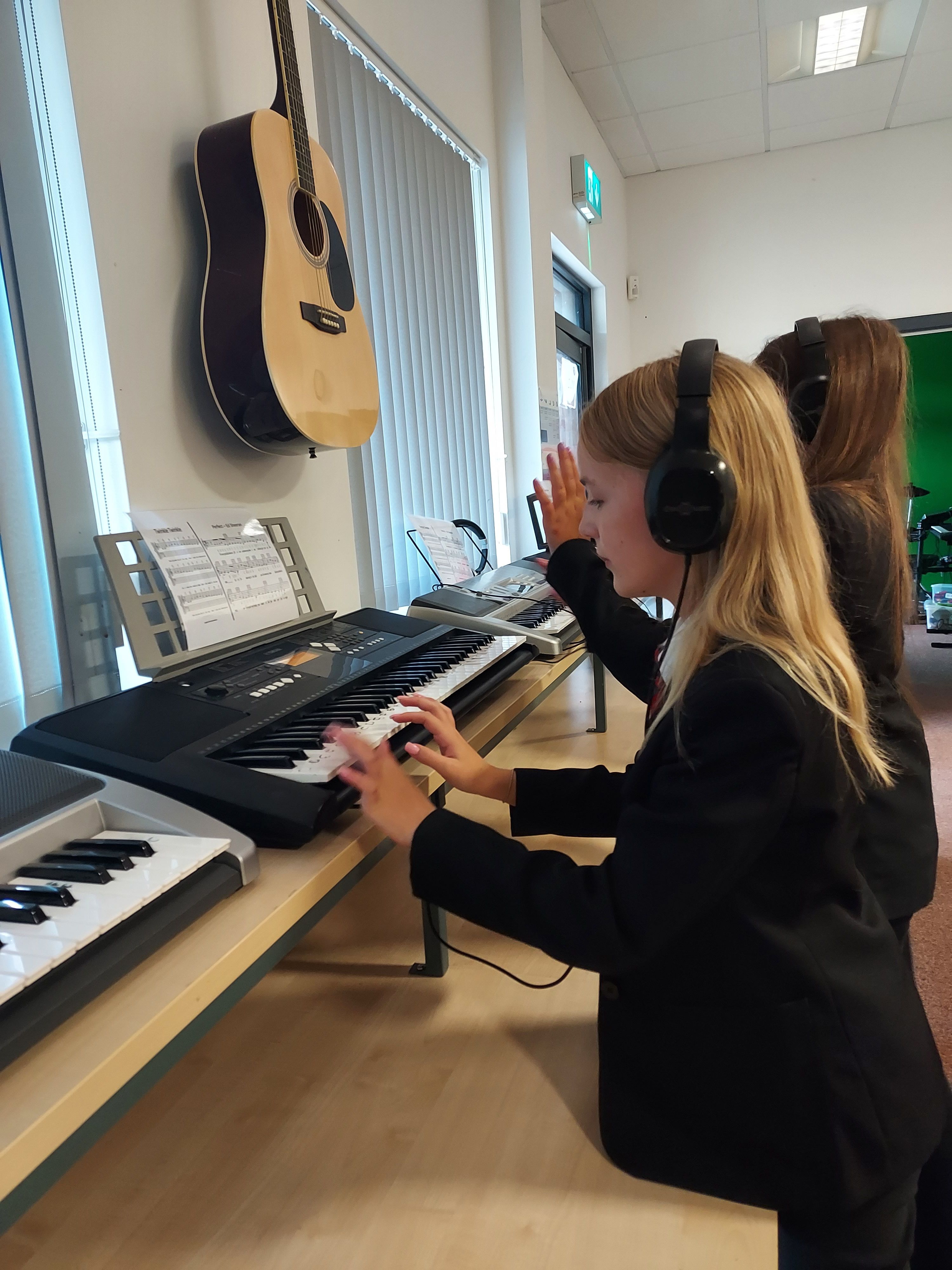 Students using the keyboards in the Music room.