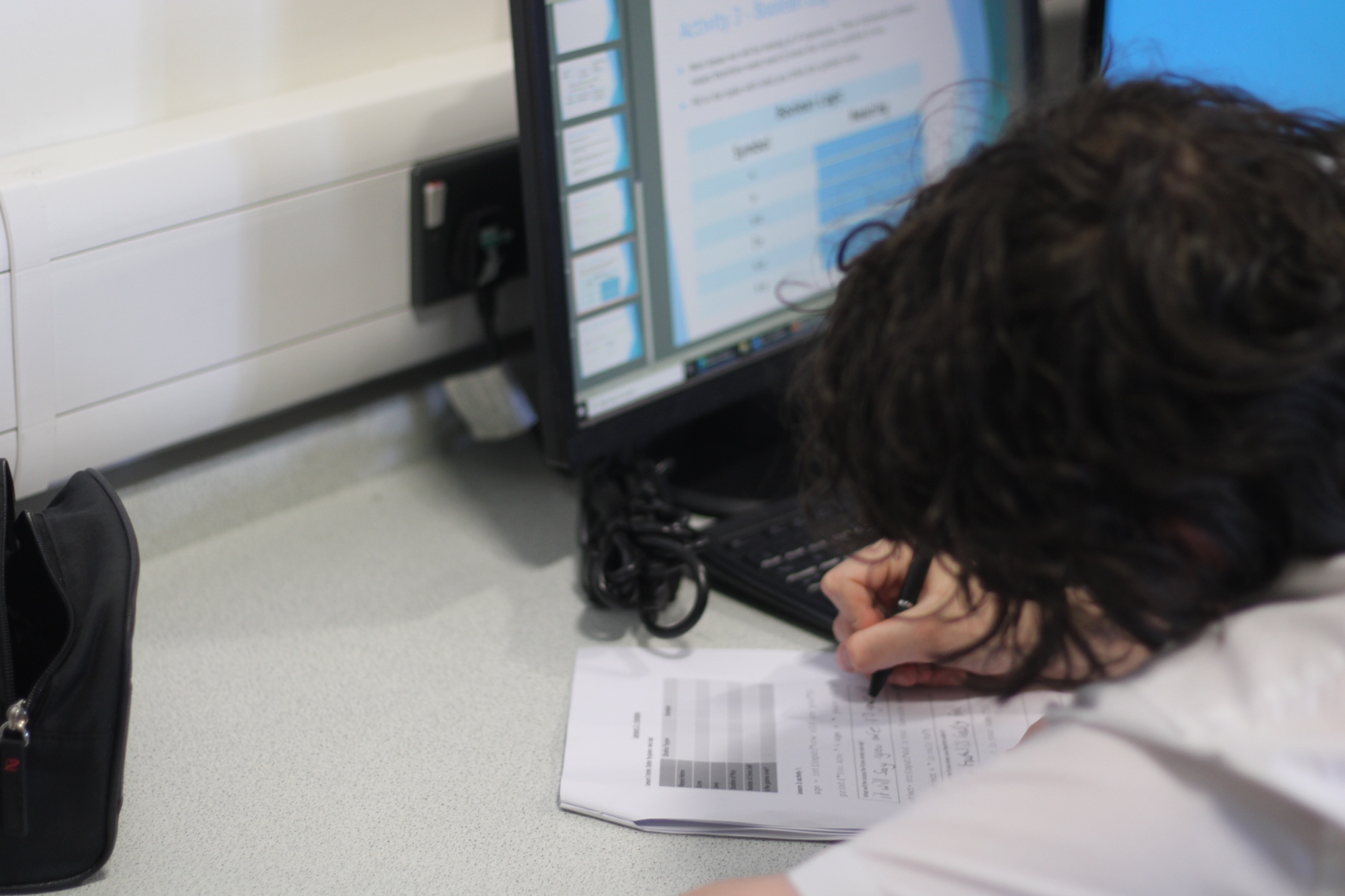 A student using the computer in their ICT lesson.