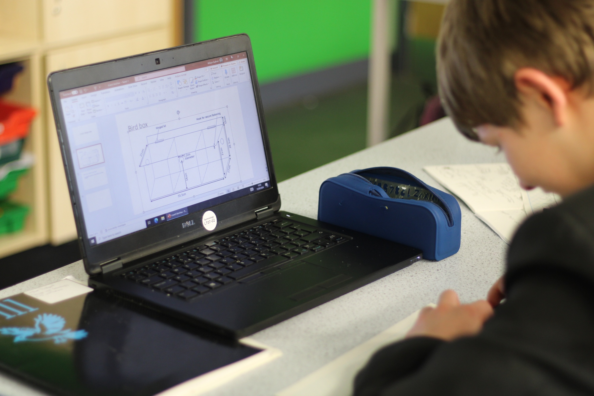 Student using a laptop to support with their D&T lesson.