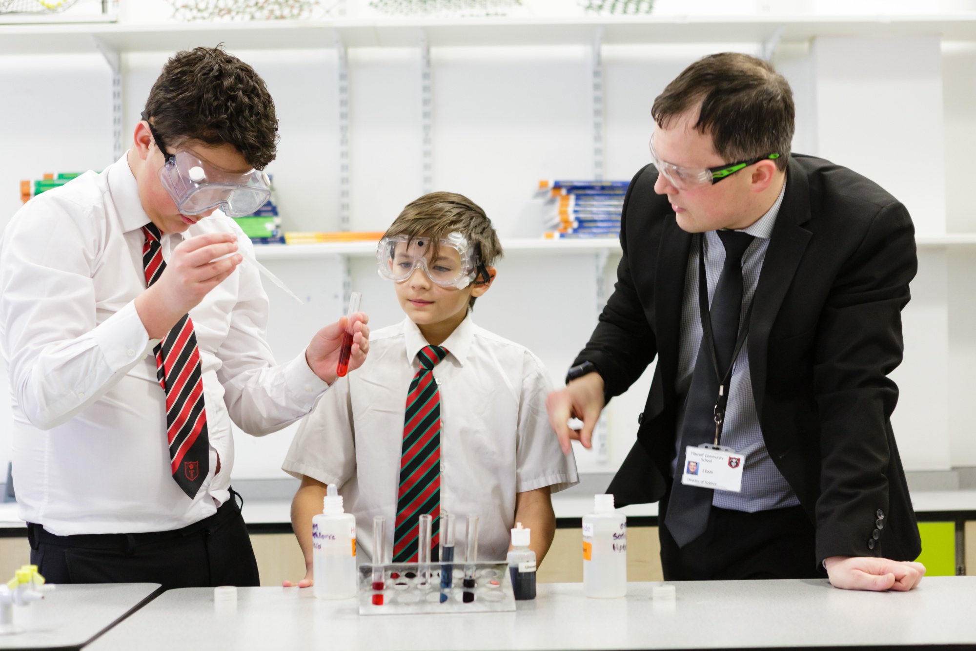 Students being supported with an experiment during a science lesson.