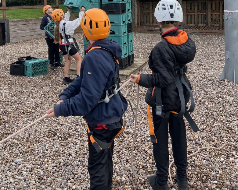 Some Year 7 students taking part in an assault course at The Mill Adventure Base.