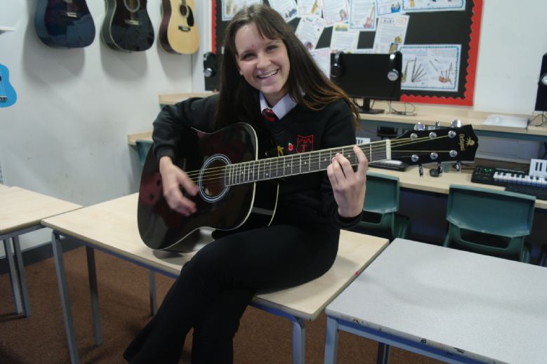 A Tibshelf pupil playing the guitar.