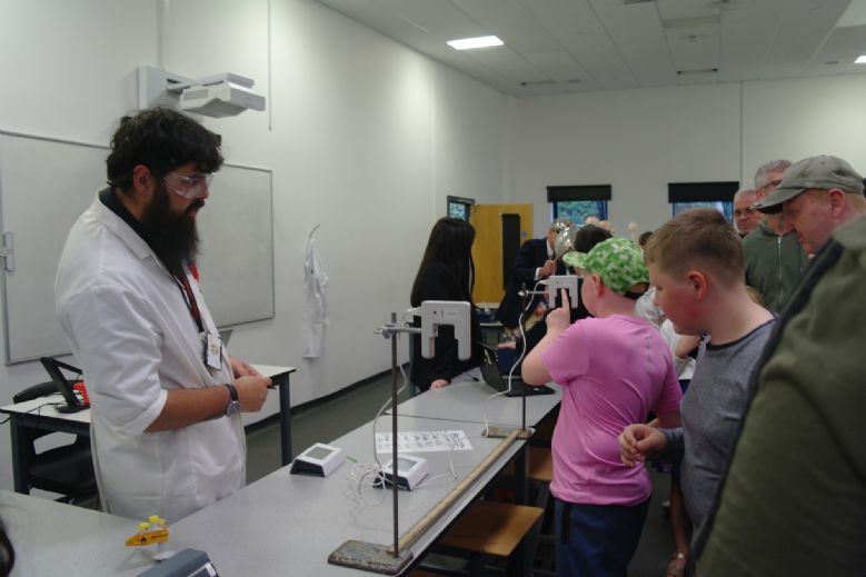 Science teacher leading an experiment demo.