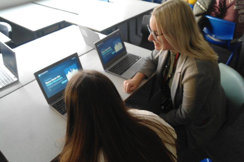 Open Evening 2026 - Maths Teacher working with pupil on a maths game at the computer.
