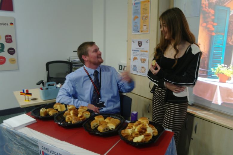 Pupil and staff having a go at conversing in French.