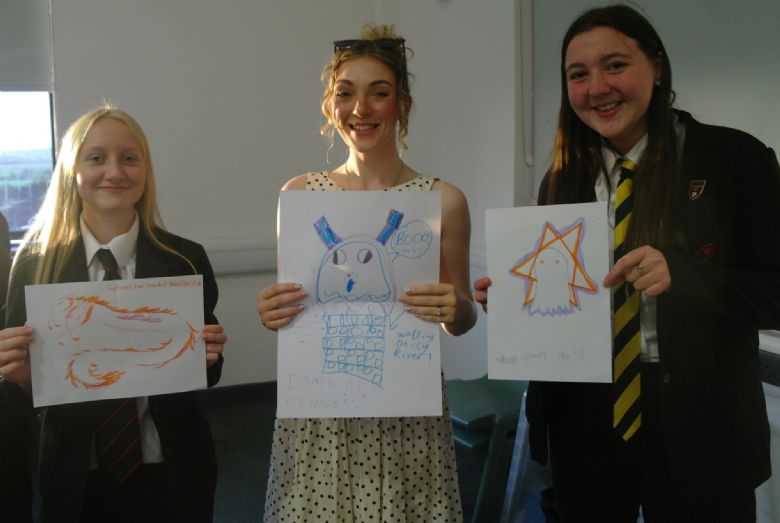 Pupils and staff showcasing some of the pupil's creepy creature drawings!