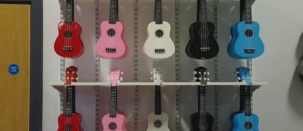 Two rows of colourful ukuleles in the music room at Tibshelf Community School.